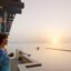 banana island doha anantara overwater villa sunset couple 01 1920x1037